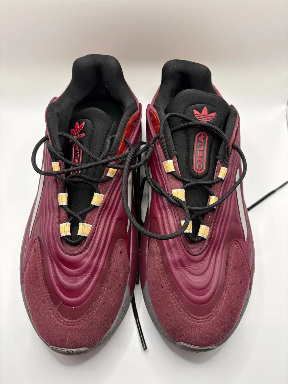 adidas OZELIA Men’s Burgundy and Black Running Sneaker with Yellow Accents
